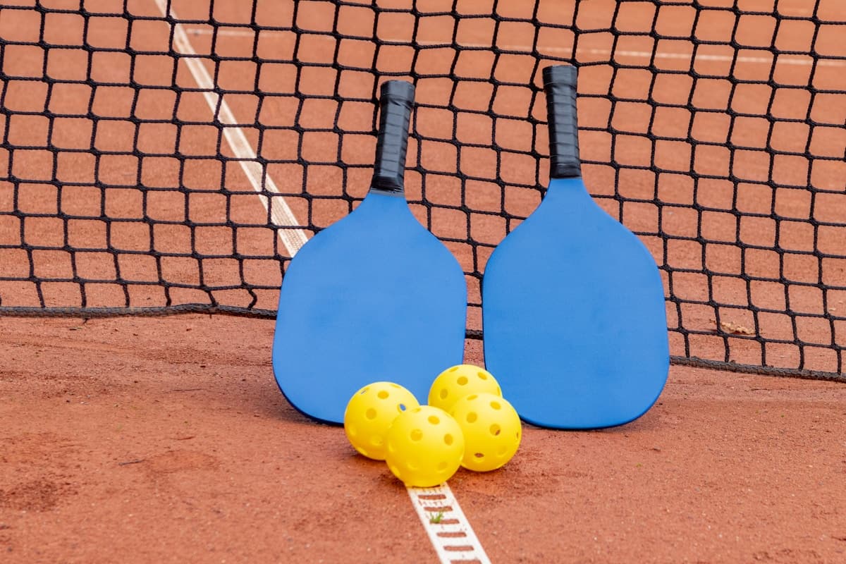 Pickleball paddles and balls on a court